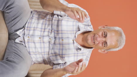 Vertical-video-of-Man-experiencing-joy-looking-at-camera.